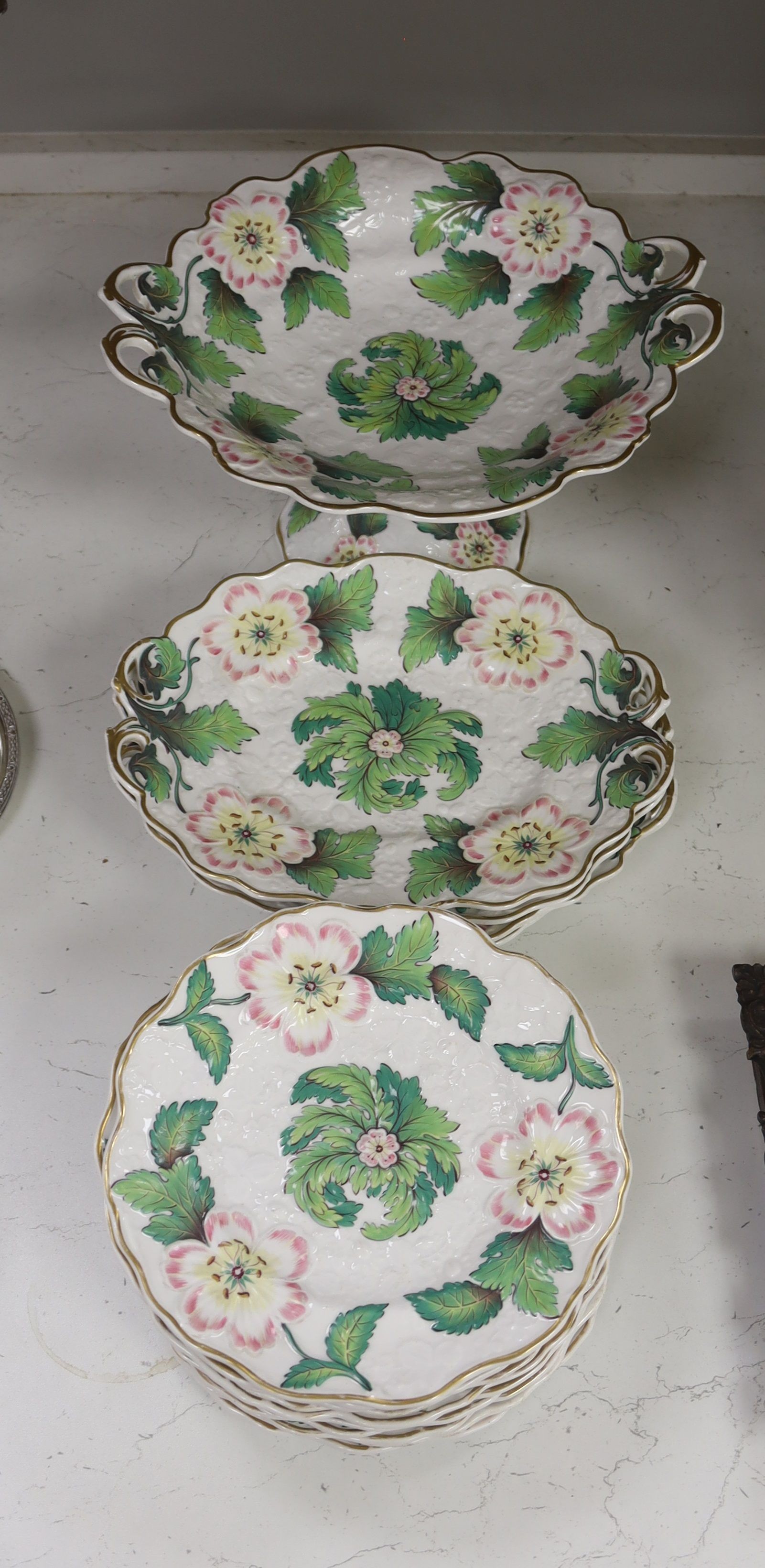 An English porcelain part dessert service, circa 1835 comprising a centrepiece, four serving dishes and ten plates